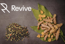 Turmeric root and black peppercorns on leaves representing natural absorption and whole turmeric benefits.